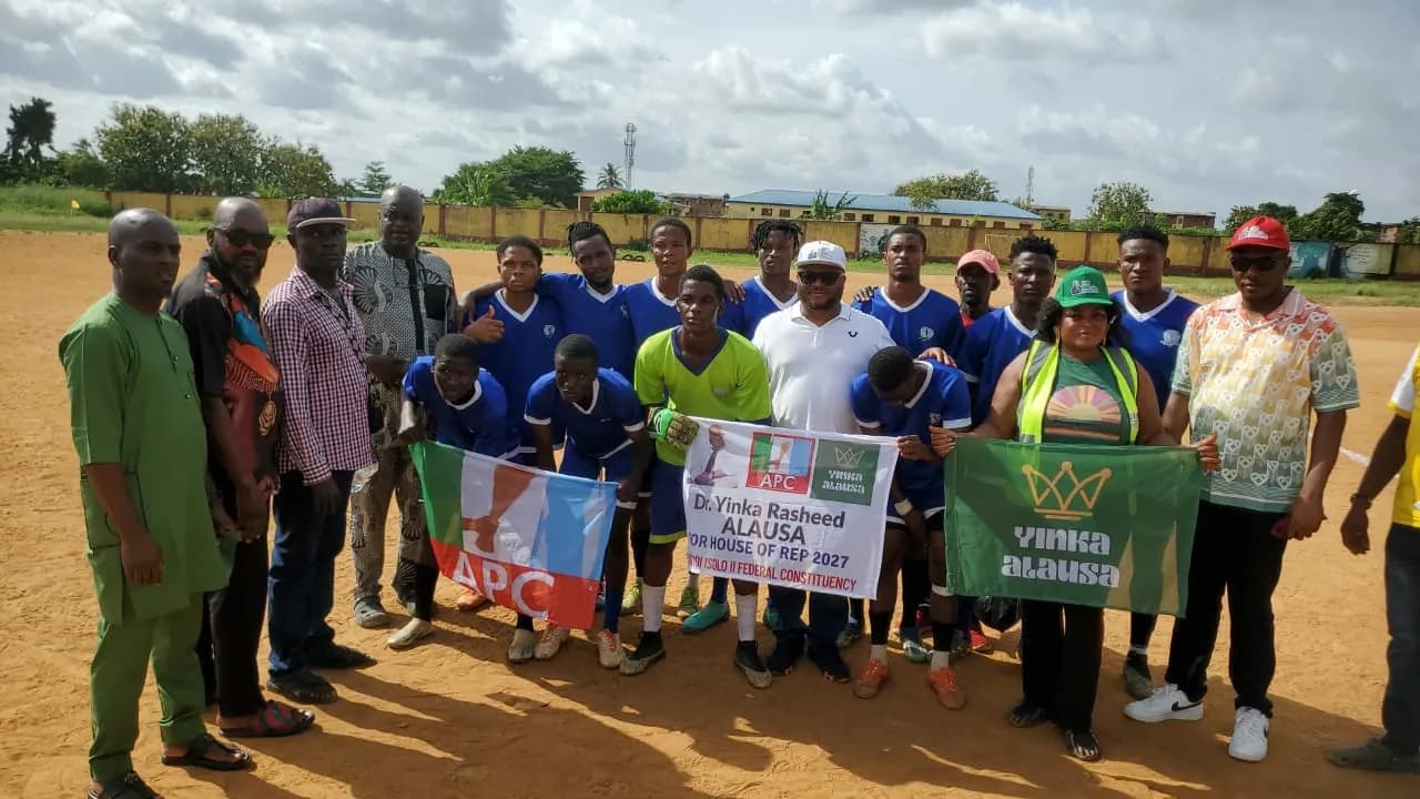 Dr. Rasheed Olayinka Alausa with a youth sports team and campaign banners